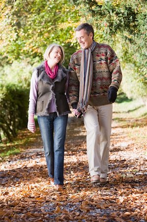 simsearch:400-04035087,k - Senior couple walking along autumn path through woods Stock Photo - Budget Royalty-Free & Subscription, Code: 400-04035004