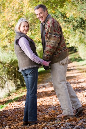 simsearch:400-04035087,k - Senior couple on woodland walk through autumn woods Stock Photo - Budget Royalty-Free & Subscription, Code: 400-04035005