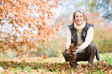 simsearch:400-04035087,k - Senior woman collecting autumn leaves on walk Stock Photo - Budget Royalty-Free & Subscription, Code: 400-04035077