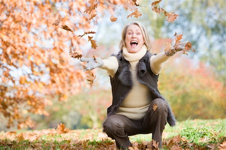 simsearch:400-04035087,k - Senior woman throwing autumn leaves in the air Stock Photo - Budget Royalty-Free & Subscription, Code: 400-04035078