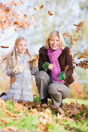 simsearch:400-04035087,k - Mother and daughter throwing autumn leaves in the air Stock Photo - Budget Royalty-Free & Subscription, Code: 400-04035079