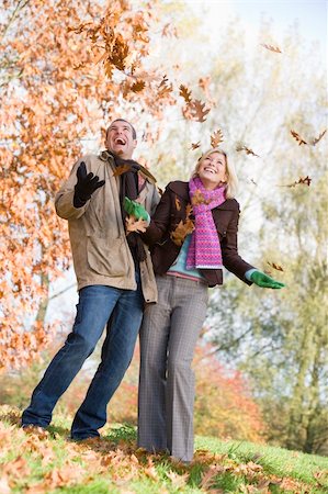 simsearch:400-04035087,k - Young couple having fun with autumn leaves in garden Stock Photo - Budget Royalty-Free & Subscription, Code: 400-04035070