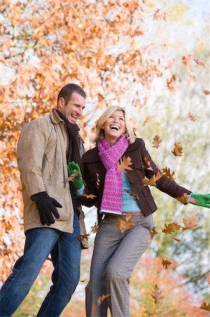 simsearch:400-04035087,k - Young couple throwing autumn leaves in the air Stock Photo - Budget Royalty-Free & Subscription, Code: 400-04035071
