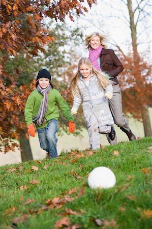 simsearch:400-04035087,k - Mother and children playing football in autumn garden Stock Photo - Budget Royalty-Free & Subscription, Code: 400-04035085
