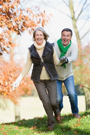 simsearch:400-04035087,k - Senior man chasing woman through countryside Stock Photo - Budget Royalty-Free & Subscription, Code: 400-04035089