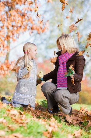 simsearch:400-04035087,k - Mother and daughter throwing autumn leaves in the air Stock Photo - Budget Royalty-Free & Subscription, Code: 400-04035080