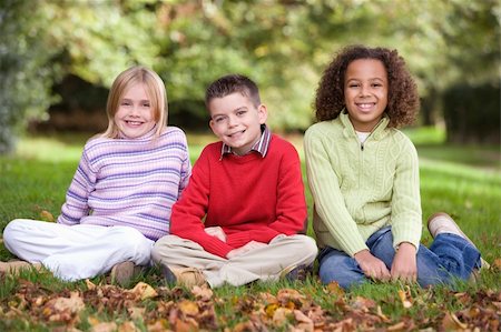 Group of children sitting in autumn garden Stock Photo - Budget Royalty-Free & Subscription, Code: 400-04035101