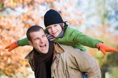 simsearch:400-04035087,k - Father giving son piggyback in autumn woodland Stock Photo - Budget Royalty-Free & Subscription, Code: 400-04035136