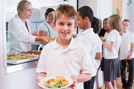 Schoolboy holding plate of lunch in school cafeteria Stock Photo - Budget Royalty-Free & Subscription, Code: 400-04036571