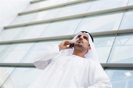 A Middle Eastern businessman talking on the phone outside an off Stock Photo - Budget Royalty-Free & Subscription, Code: 400-04036998