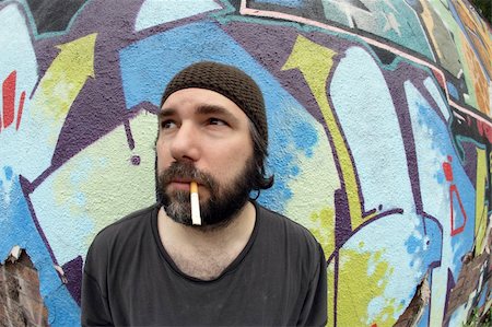 A homeless man on the city streets, smoking and pondering. Stock Photo - Budget Royalty-Free & Subscription, Code: 400-04037585
