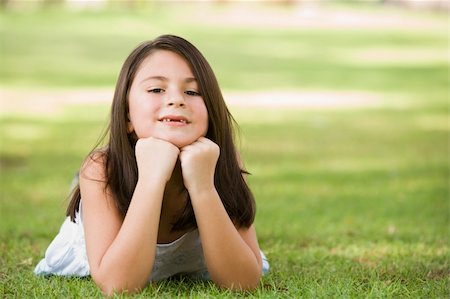 Girl relaxing in park looking at camera Stock Photo - Budget Royalty-Free & Subscription, Code: 400-04038291
