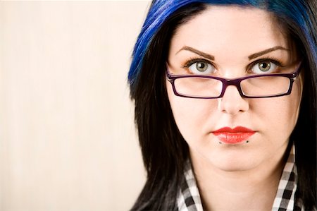 simsearch:400-04016564,k - Portrait of a cute rockabilly woman looking over her glasses Stock Photo - Budget Royalty-Free & Subscription, Code: 400-04038962