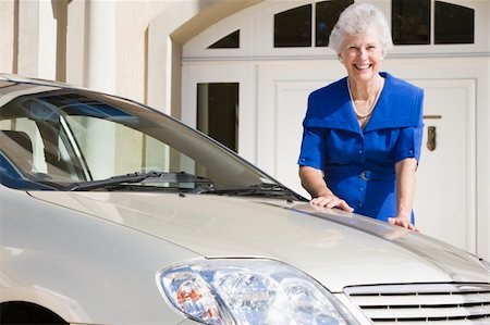Senior woman standing next to new car outside house Stock Photo - Budget Royalty-Free & Subscription, Code: 400-04031422