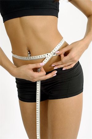 simsearch:400-07219376,k - A tanned slim young woman measuring her waistline. Stock Photo - Budget Royalty-Free & Subscription, Code: 400-04032811