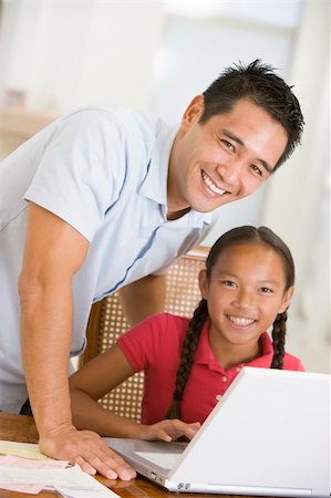 simsearch:400-05751173,k - Man and young girl with laptop in dining room smiling Stock Photo - Budget Royalty-Free & Subscription, Code: 400-04044128