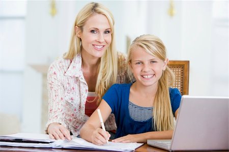 simsearch:400-05751173,k - Woman helping young girl with laptop do homework in dining room Stock Photo - Budget Royalty-Free & Subscription, Code: 400-04044138