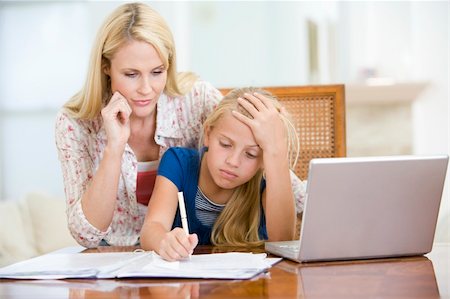 simsearch:400-05751173,k - Woman helping young girl with laptop do homework in dining room Stock Photo - Budget Royalty-Free & Subscription, Code: 400-04044139