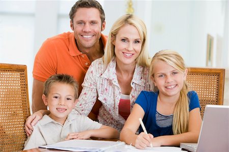 simsearch:400-05751173,k - Couple helping two young children with laptop do homework in din Stock Photo - Budget Royalty-Free & Subscription, Code: 400-04044214