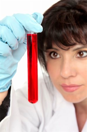 simsearch:400-04881594,k - Closeup of woman holding a  test tube and looking intently.  Focus to test tube. Stock Photo - Budget Royalty-Free & Subscription, Code: 400-04044367