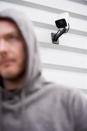 Surveillance Camera And Young Man In Hooded Sweatshirt Stock Photo - Budget Royalty-Free & Subscription, Code: 400-04048228