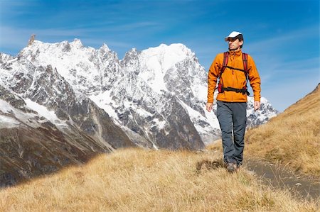 simsearch:400-04269017,k - Male trekker walks along a mountain path, in background the Grand Jourasses peaks, fall season; Val Veny, Mont Blanc massif, Courmayeur, Italy Photographie de stock - Aubaine LD & Abonnement, Code: 400-04048561