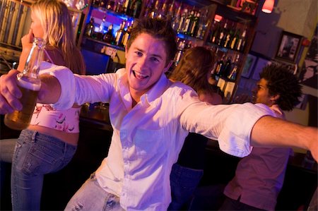 Young man in nightclub approaching camera with arms outstretched Stock Photo - Budget Royalty-Free & Subscription, Code: 400-04040215