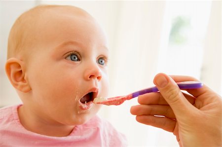 Mother feeding baby food to baby Stock Photo - Budget Royalty-Free & Subscription, Code: 400-04041714