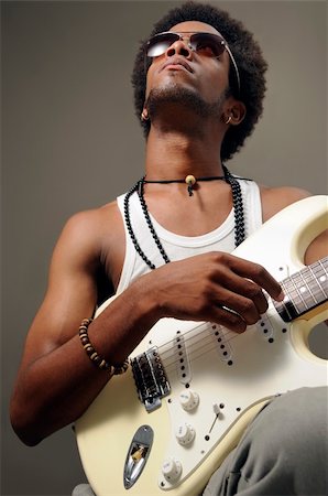 Portrait of young african man playing electric guitar Stock Photo - Budget Royalty-Free & Subscription, Code: 400-04042294