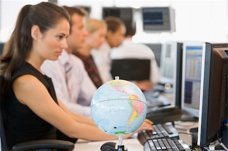Five businesspeople in office space with desk globe in foregroun Stock Photo - Budget Royalty-Free & Subscription, Code: 400-04042671
