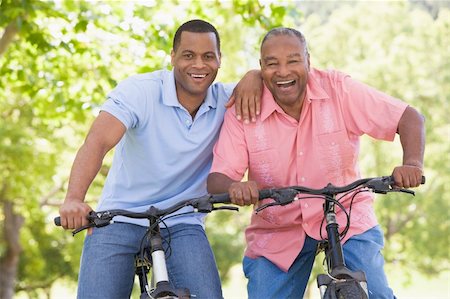 senior women mountain biking - Two men on bikes outdoors smiling Stock Photo - Budget Royalty-Free & Subscription, Code: 400-04042831