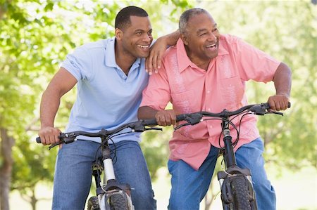 senior women mountain biking - Two men on bikes outdoors smiling Stock Photo - Budget Royalty-Free & Subscription, Code: 400-04043054