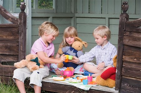 summerhouse - Three young children in shed playing tea and smiling Stock Photo - Budget Royalty-Free & Subscription, Code: 400-04043131