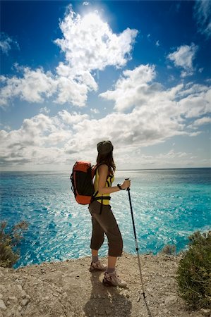 young woman hiking and looking up to the sky Stock Photo - Budget Royalty-Free & Subscription, Code: 400-04043243