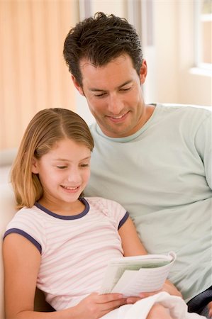 father reading to child portrait - Man and young girl in living room reading book and smiling Stock Photo - Budget Royalty-Free & Subscription, Code: 400-04043809