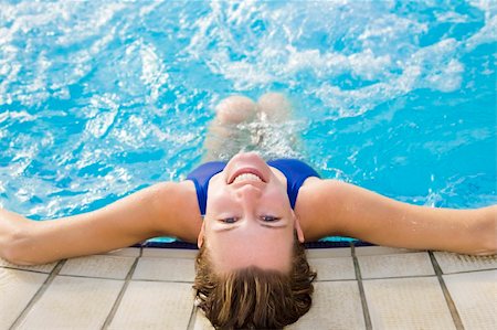 simsearch:6108-06907511,k - Portrait of young woman sitting in swimming pool, rear view Stock Photo - Budget Royalty-Free & Subscription, Code: 400-04056519