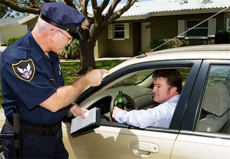 Angry police officer pulls over drunk driver, driving with an open beer. Stock Photo - Budget Royalty-Free & Subscription, Code: 400-04058354