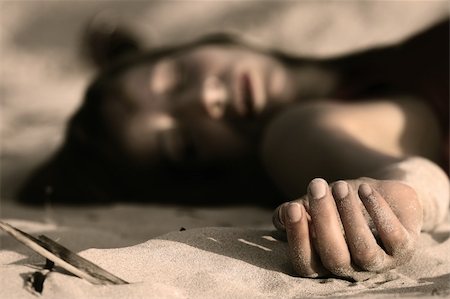 dead body women - woman playing dead, lying in the sand Stock Photo - Budget Royalty-Free & Subscription, Code: 400-04052365