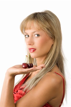 blond sensual girl with red lips and red dress keeping cherries in her hand Stock Photo - Budget Royalty-Free & Subscription, Code: 400-04069809