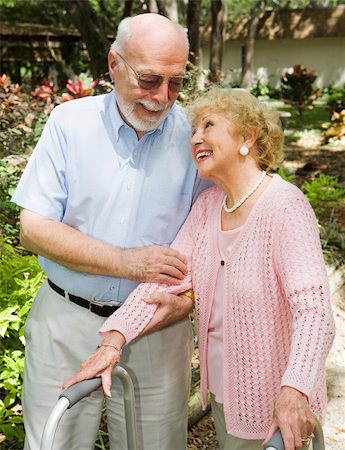 Disabled senior woman looks adoringly at her husband as he helps her walk. Stock Photo - Budget Royalty-Free & Subscription, Code: 400-04061258
