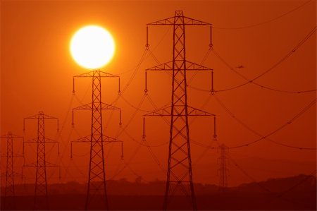 Sun above a row of electricity pylons Stock Photo - Budget Royalty-Free & Subscription, Code: 400-04062161