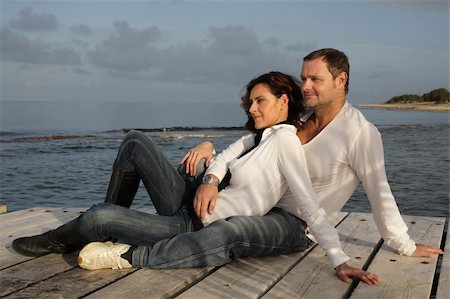 attractive couple relaxing on a pier Stock Photo - Budget Royalty-Free & Subscription, Code: 400-04062644