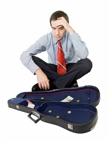 devalue - Desperate bankrupt businessman sitting by a violin case and a few coins - isolated Stock Photo - Budget Royalty-Free & Subscription, Code: 400-04074041