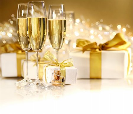 simsearch:400-05117424,k - Glasses of champagne with gold ribbon gifts Stock Photo - Budget Royalty-Free & Subscription, Code: 400-04077495