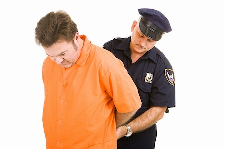 Prisoner in orange jump suit being handcuffed by police officer.  Isolated on white. Stock Photo - Budget Royalty-Free & Subscription, Code: 400-04079557