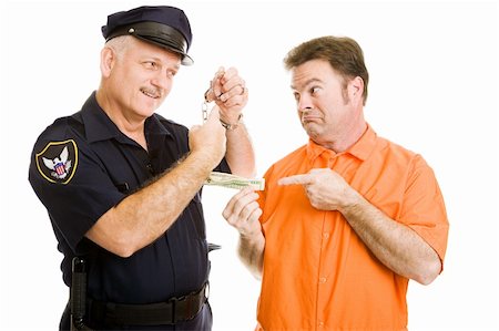 Prisoner offers policeman bribe.  Officer refuses and threatens handcuffs.  Isolated on white. Stock Photo - Budget Royalty-Free & Subscription, Code: 400-04079553