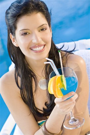 simsearch:400-06422339,k - A stunningly beautiful young hispanic woman looking drinking a cocktail next to a swimming pool Foto de stock - Super Valor sin royalties y Suscripción, Código: 400-04086326