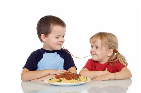 Two kids eating the same string of pasta - isolated Stock Photo - Budget Royalty-Free & Subscription, Code: 400-04081083