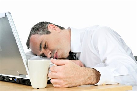 Tired businessman asleep at his desk isolated on white background Stock Photo - Budget Royalty-Free & Subscription, Code: 400-04083720