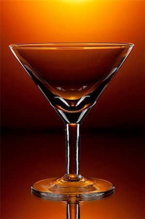 simsearch:400-04558755,k - Empty martini glass on shining red background Stock Photo - Budget Royalty-Free & Subscription, Code: 400-04094515